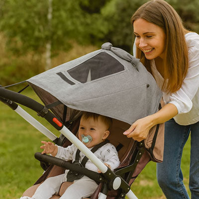 Mère-installe-pare-soleil-pour-poussette-imperméable-pour-protéger-bébé
