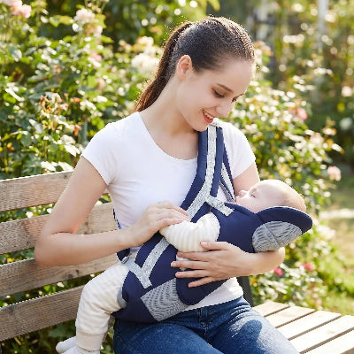 Porte bébé physiologique bleu foncé dans jardin