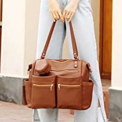 Femme-porte-dans-ses-mains-sac-à-dos-à-langer-sophistiqué
